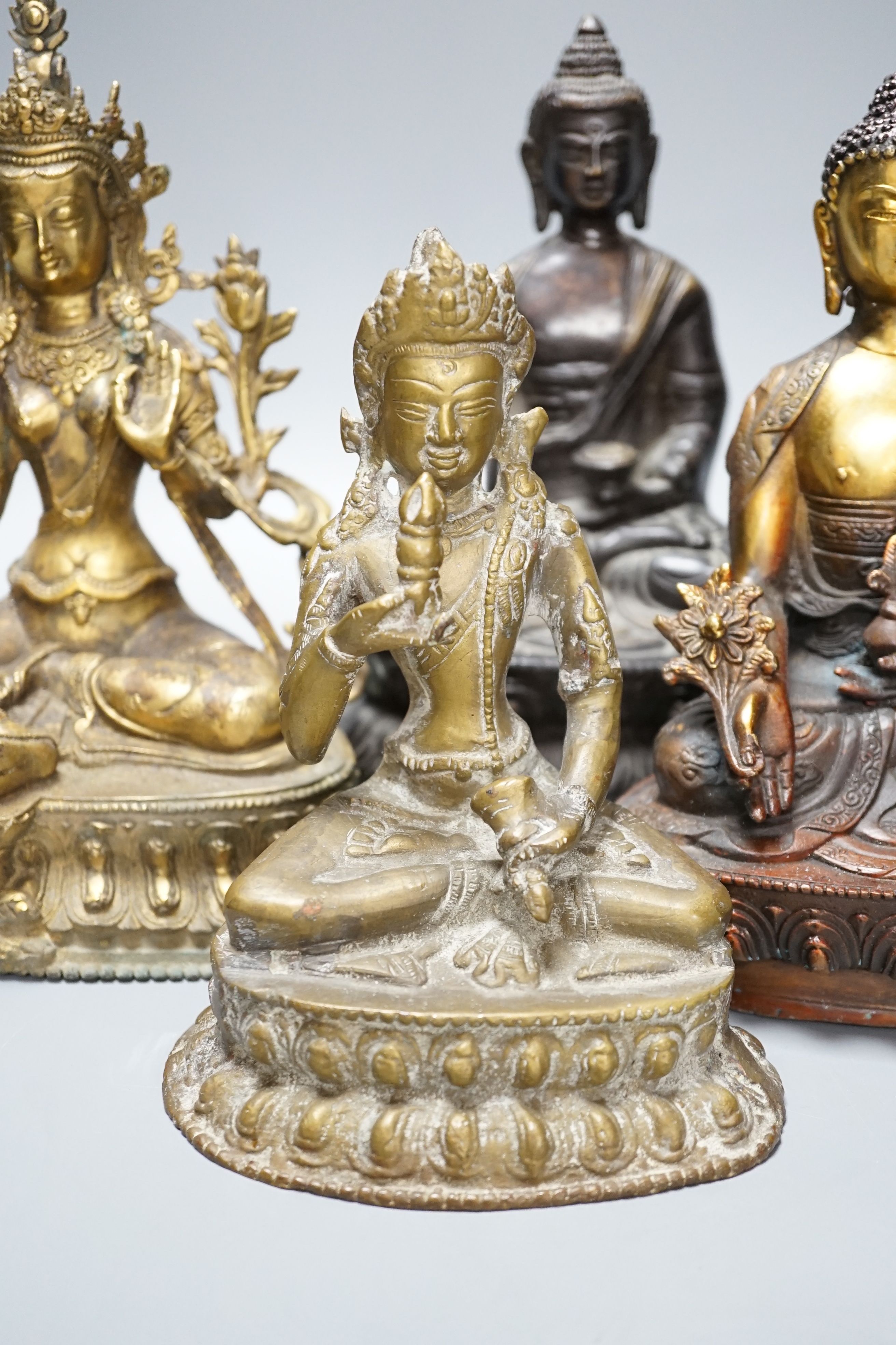 A group of five Tibetan or buddhist bronzes of deities and a Chinese bronze ‘dragon’ vase, tallest 21cm